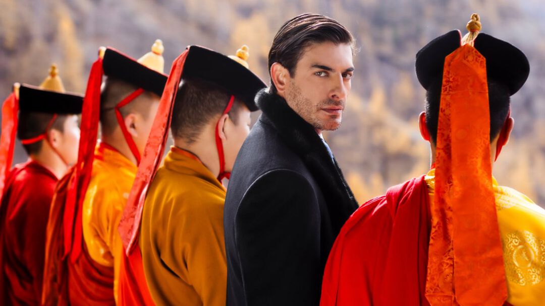 the model standing with the local monks