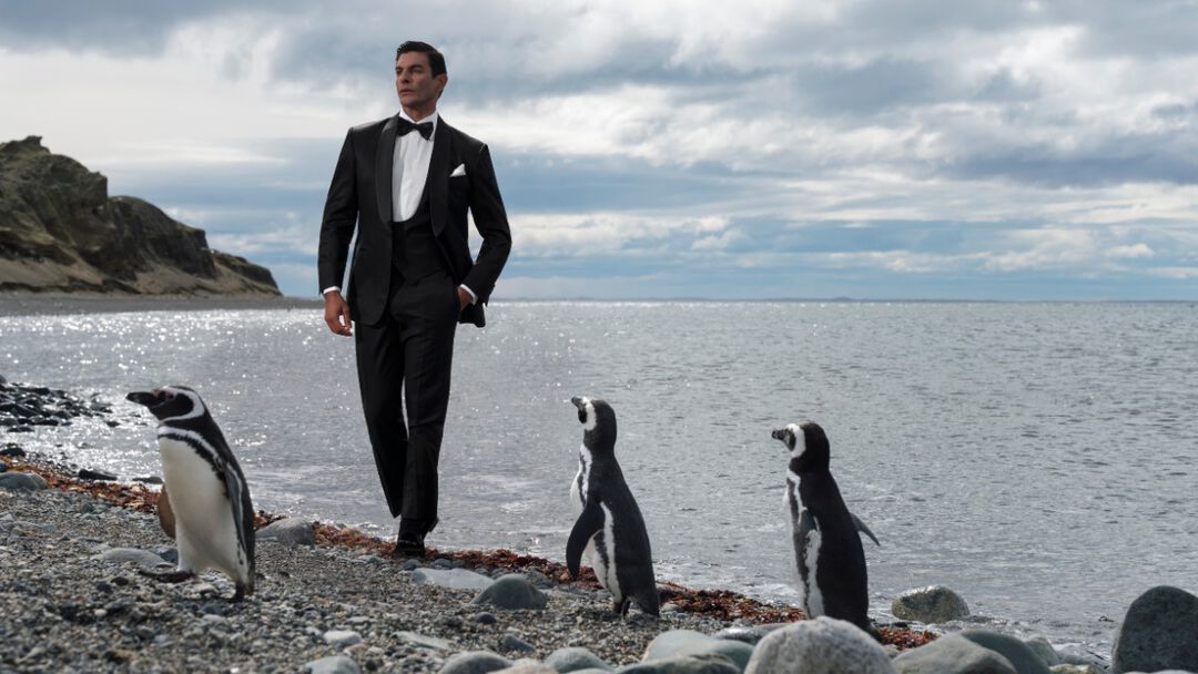 The model standing with penguins in Isla Magdalena