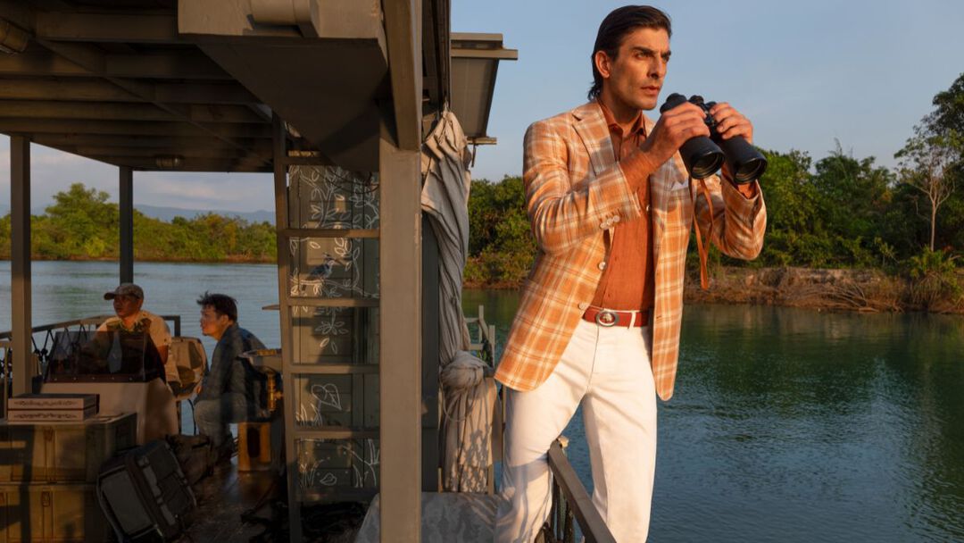 the model on a boat in Cambodian river