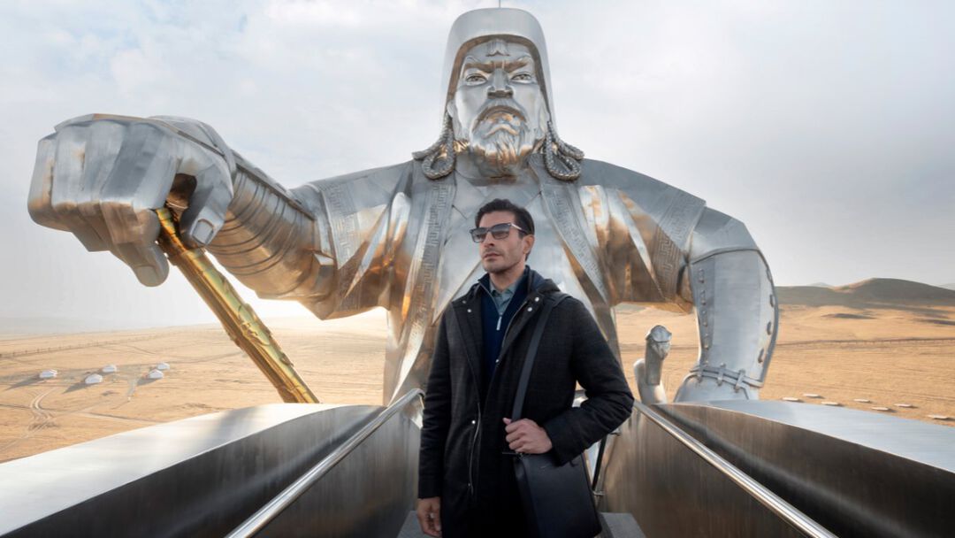 the model in front of the statue of Gengis Khan