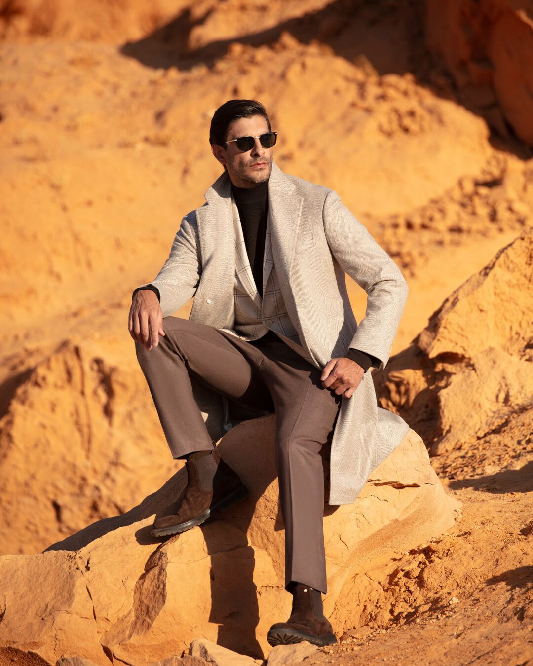 the model sitting in the cliff in Mongolia