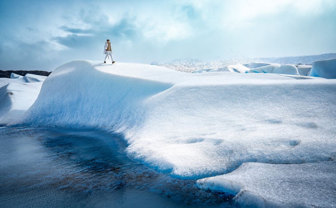 model walking on grey glacier