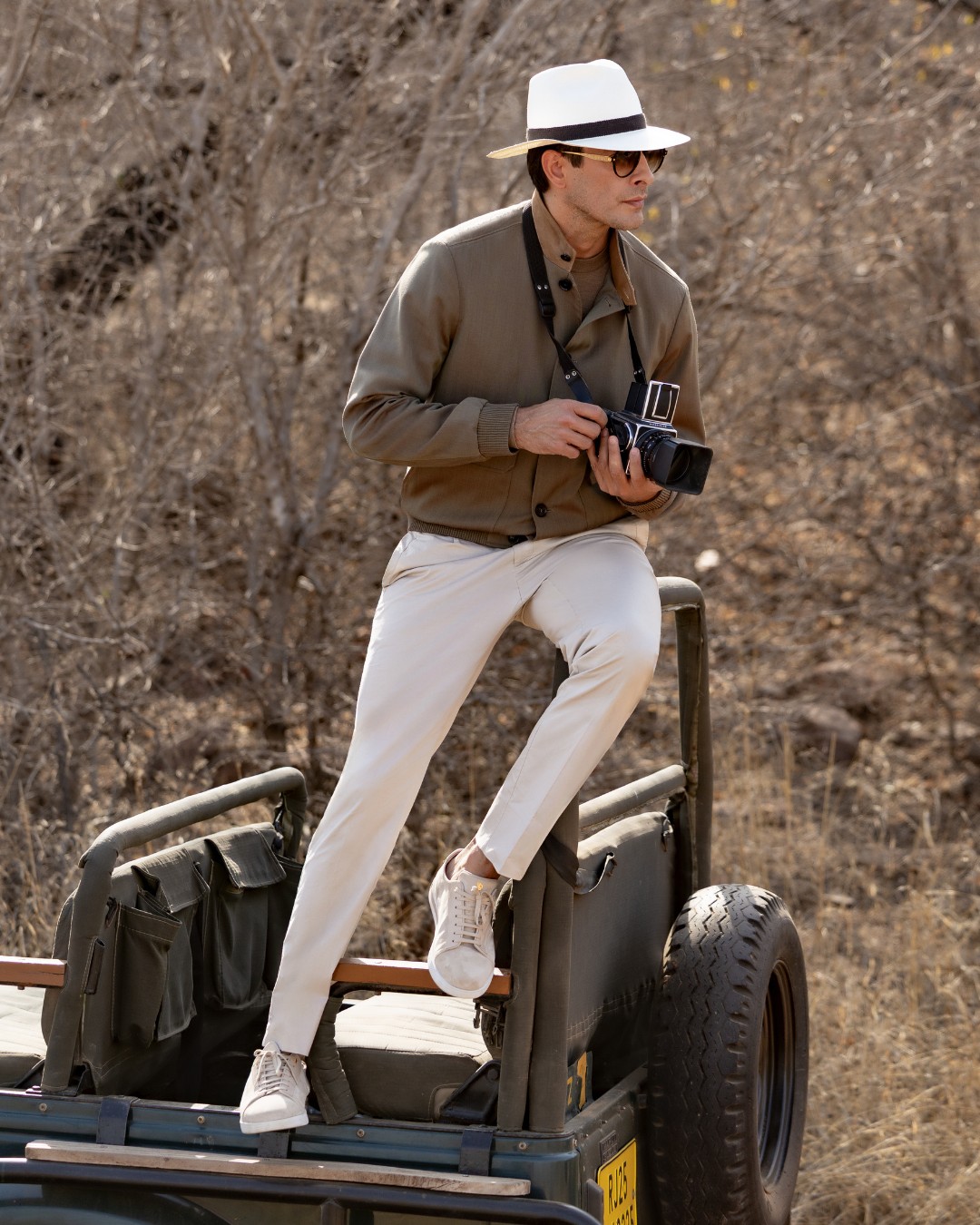 Model in Ranthambore National Park is wearing a blouson in natural stretch Solaro wool with suede inserts at the collar and the iconic SR Panama hat.