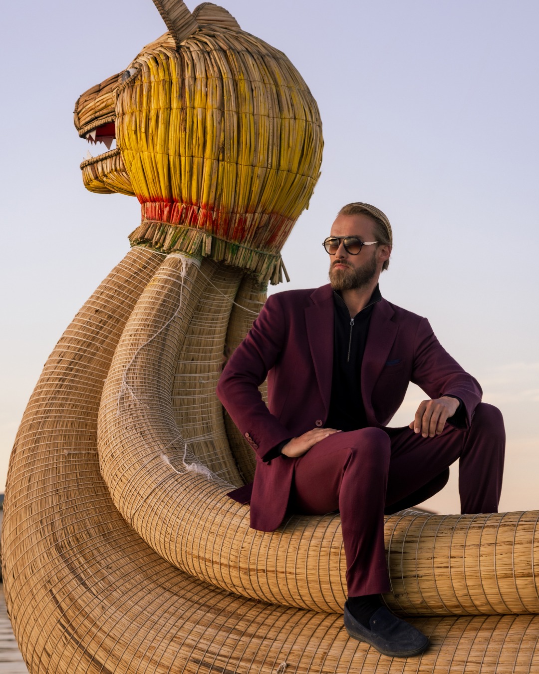The model aboard a traditional Uros boat on Lake Titicaca