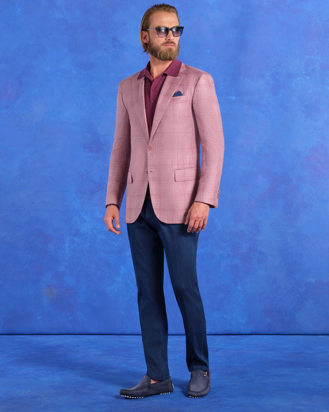 Lukas wears a two-button deconstructed jacket in wool, silk and linen over a knit polo shirt in silk and cotton with matted crocodile details