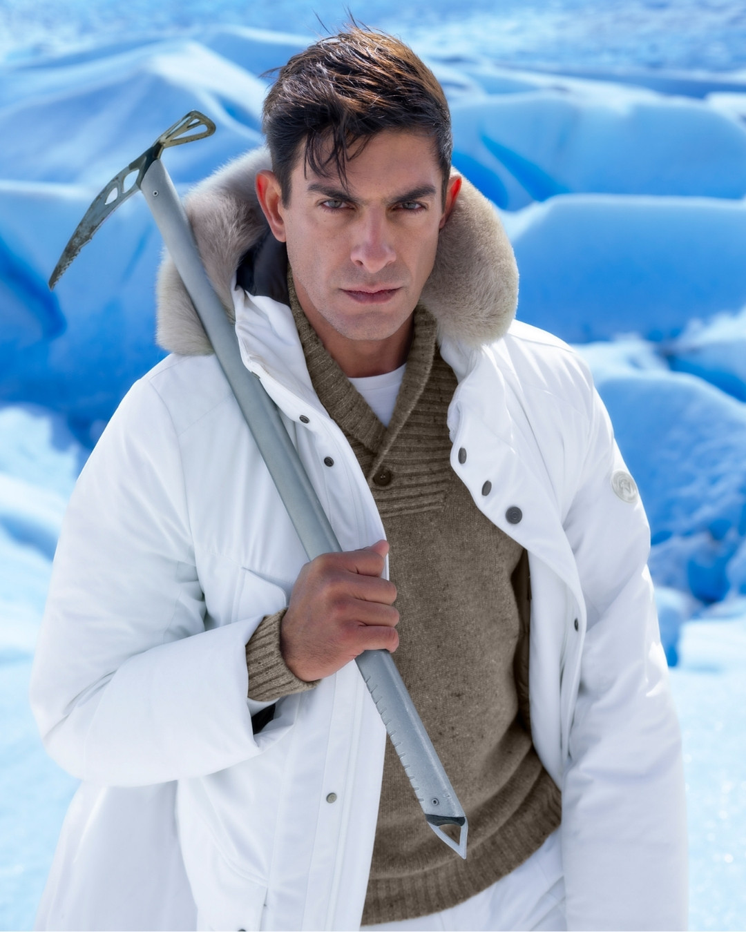 Model wearing Explorer hooded down jacket, 100% technical fabric with fox fur trim
