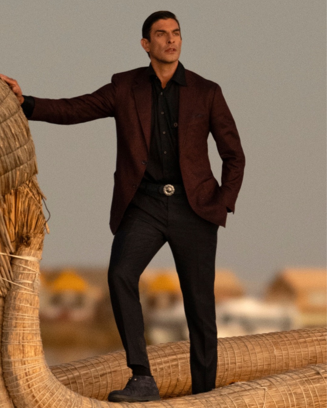 The model aboard a traditional Uros boat on Lake Titicaca