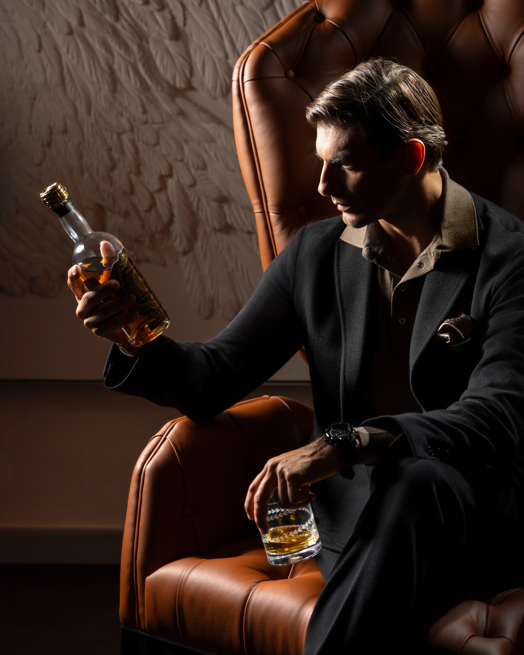 model observing the whiskey bottle