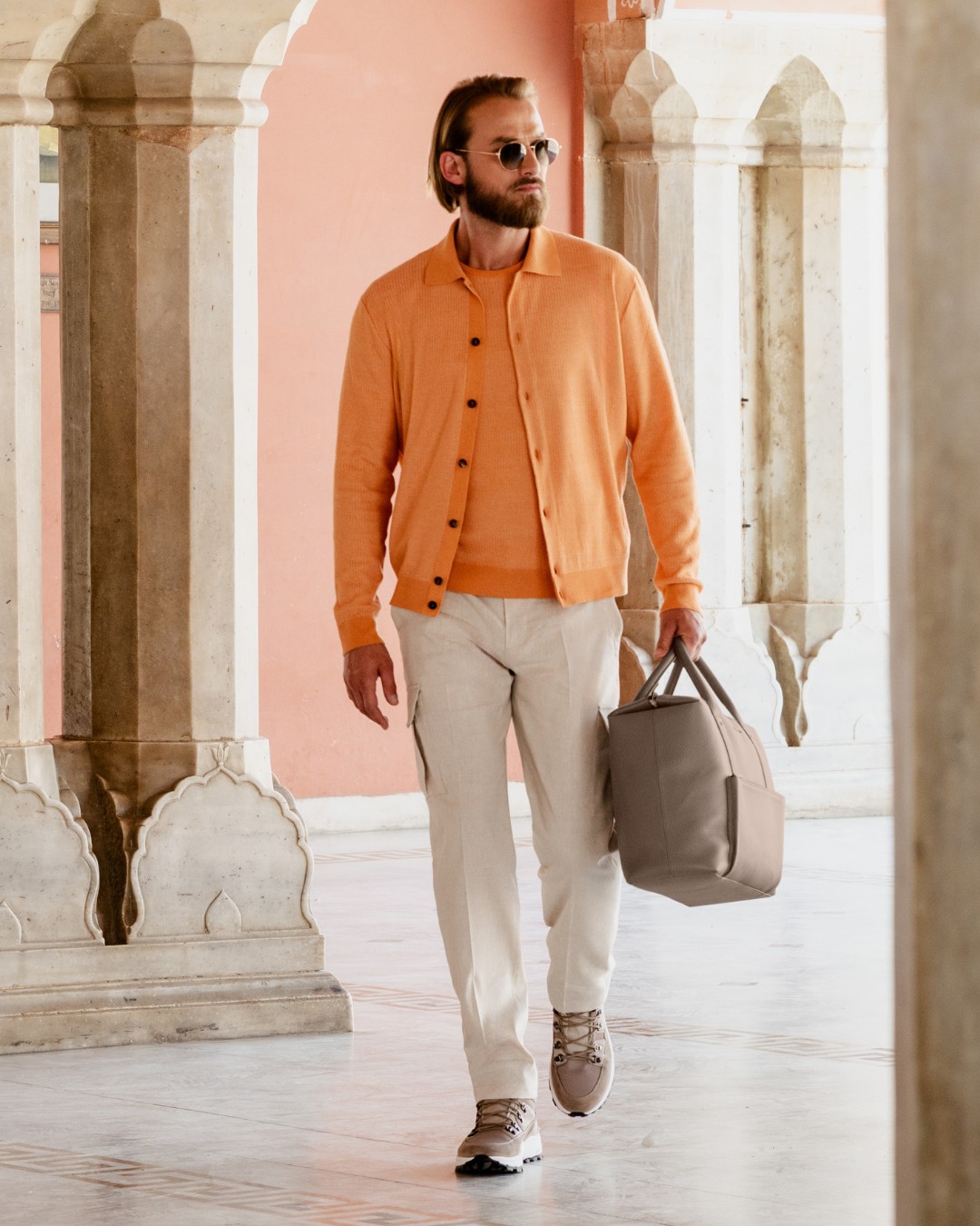 Lukas wears a knit crewneck sweater and polo in fine silk, linen and cotton in one of the seasonal colours