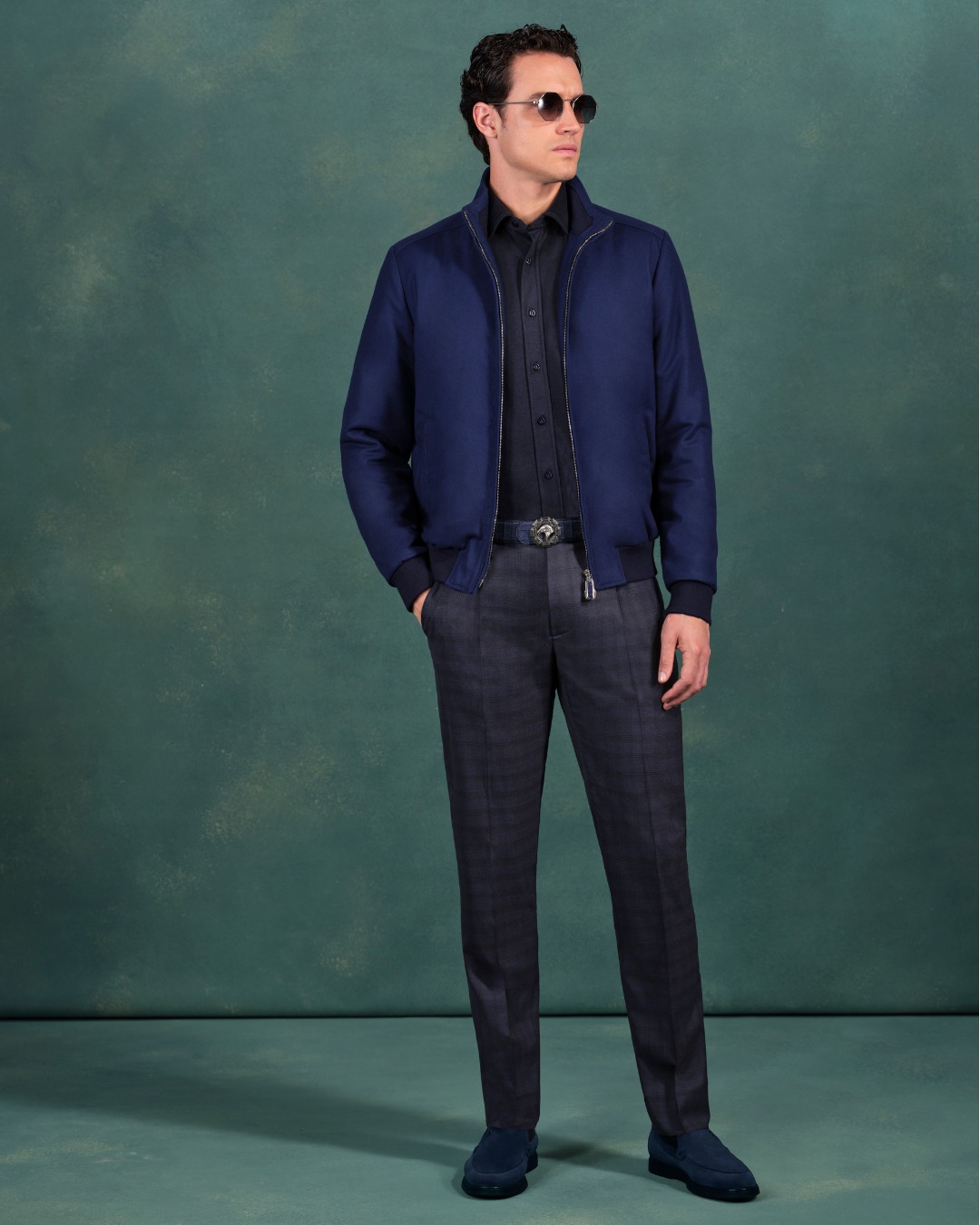 The Stefano Ricci look showcases a luxurious blouson crafted from vicu&ntilde;a and silk with crocodile detailing. Paired with a silk shirt, virgin wool trousers, and the iconic Silver Idol sunglasses.