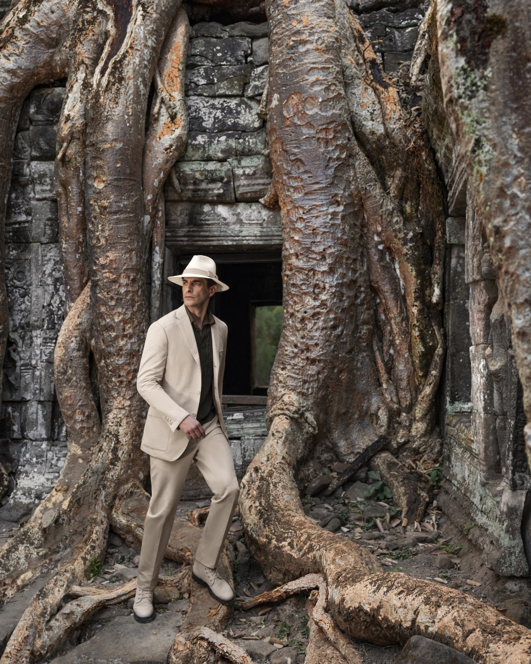 the model walking outside a Cambodian temple